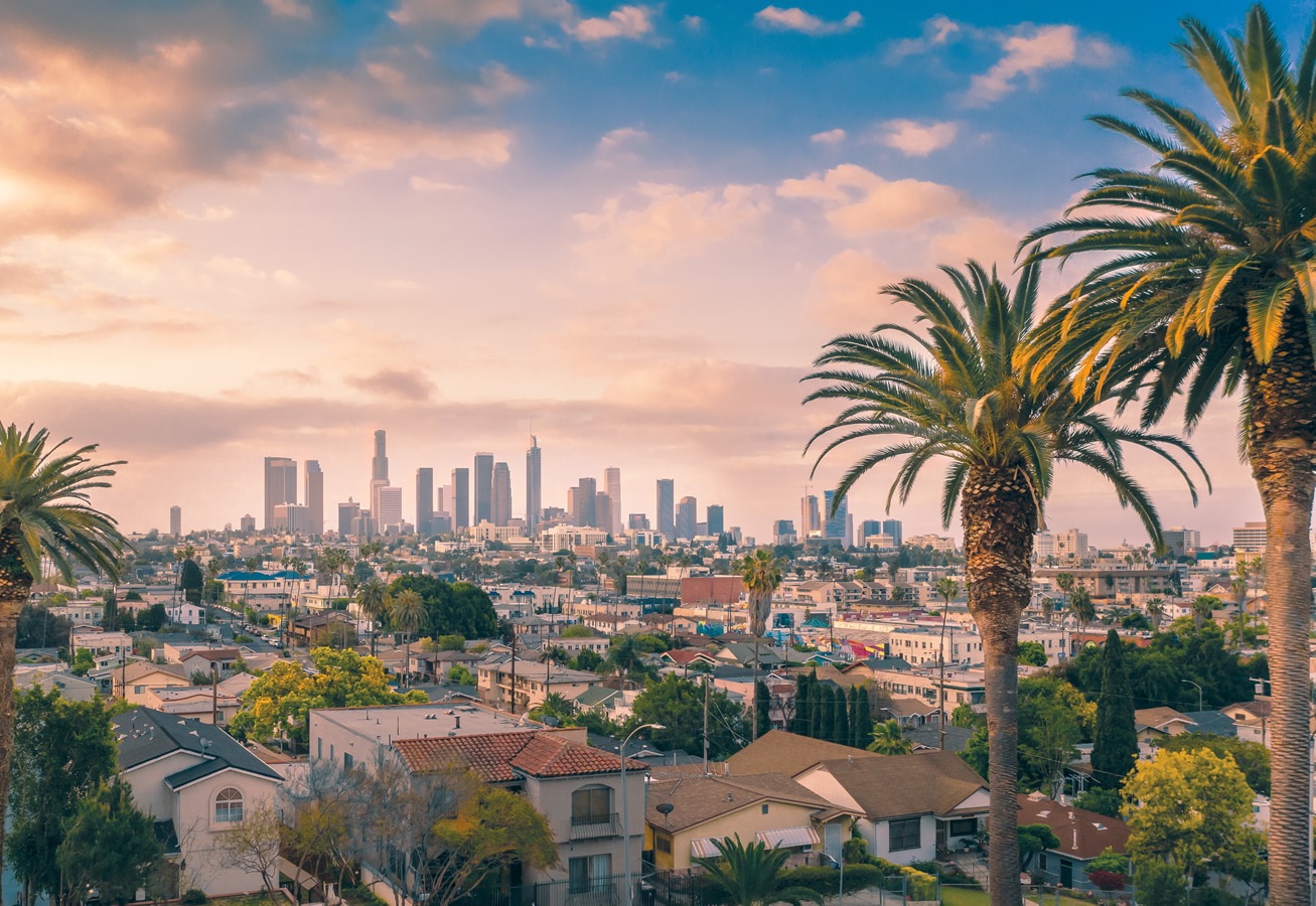 Los Angeles skyline and palm trees at sunset seen from the San Gabriel Valley