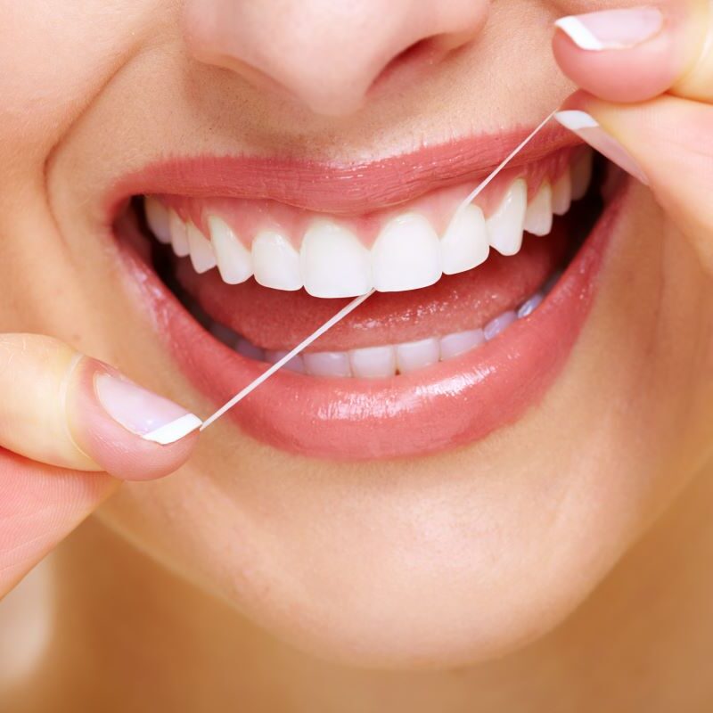 Woman Flossing Practicing Oral Health & Nutrition in La Crescenta, California